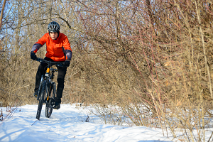 Mountain bike rider on snow covered path