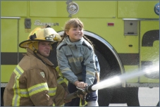Child spraying a fire hose