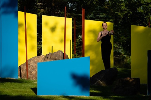 Woman posing in front of art display